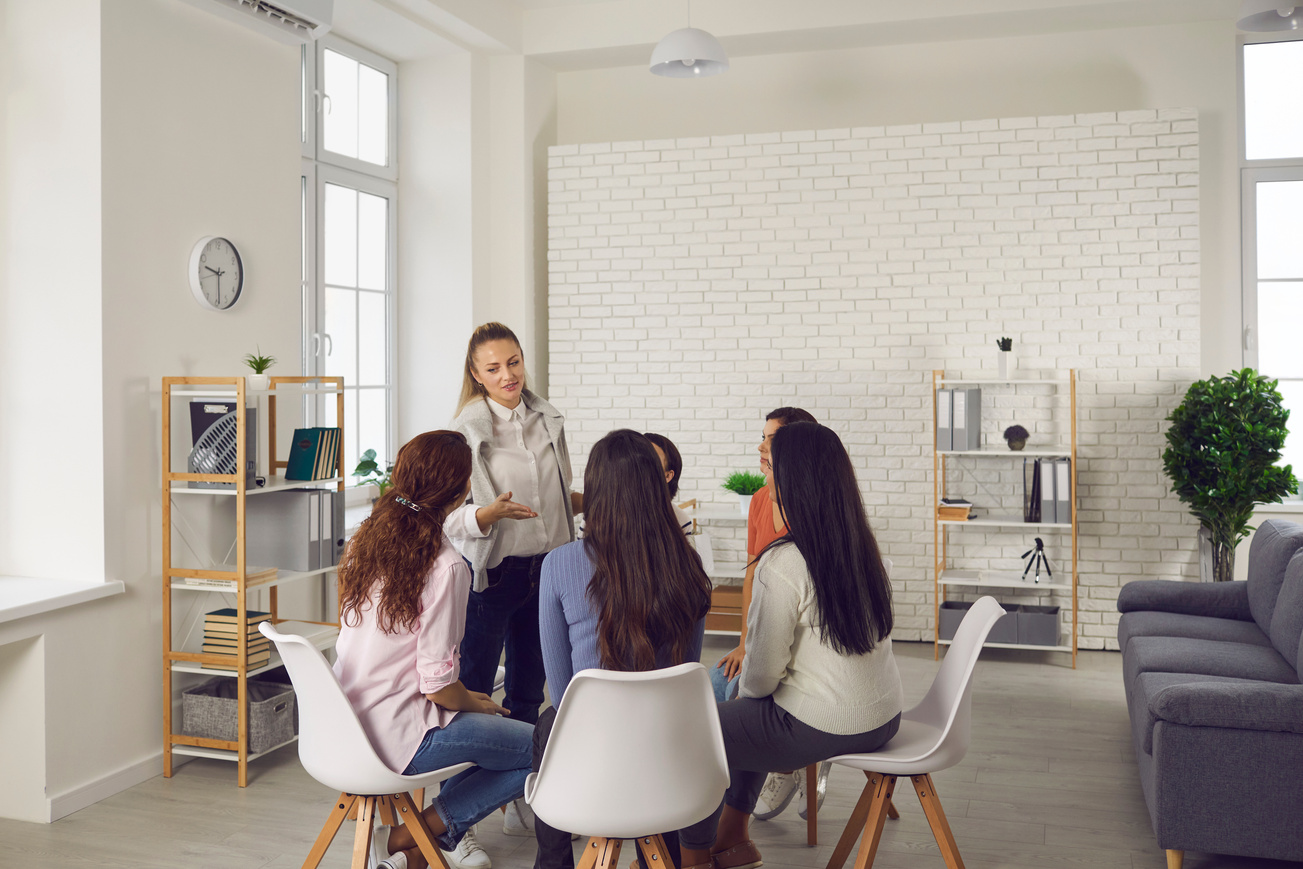 Group of Women Sitting in Circle and Listening to Professional Business or Life Coach