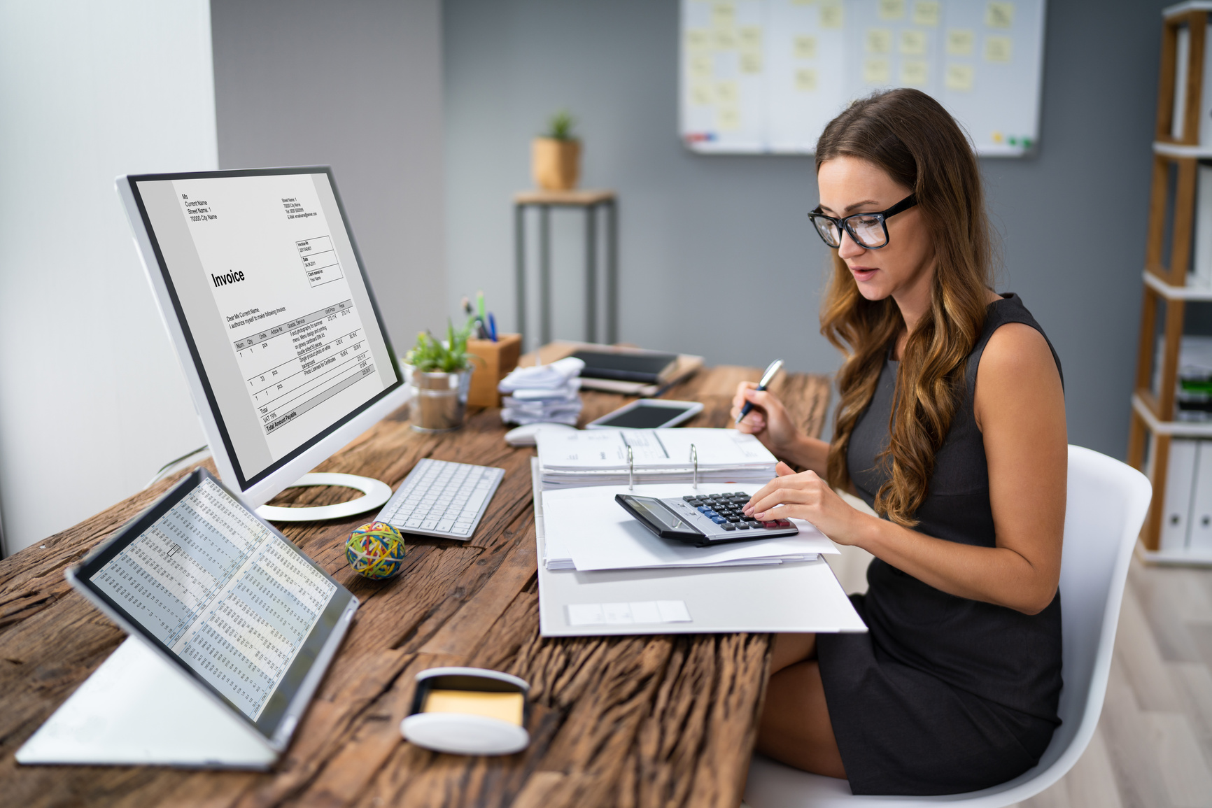 Accountant Calculating Tax At Desk